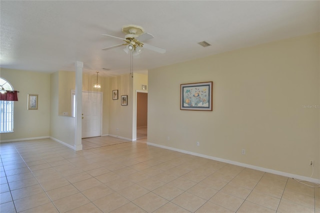 unfurnished room featuring light tile patterned floors and ceiling fan