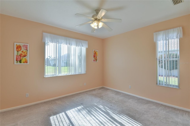 unfurnished room with ceiling fan and light carpet