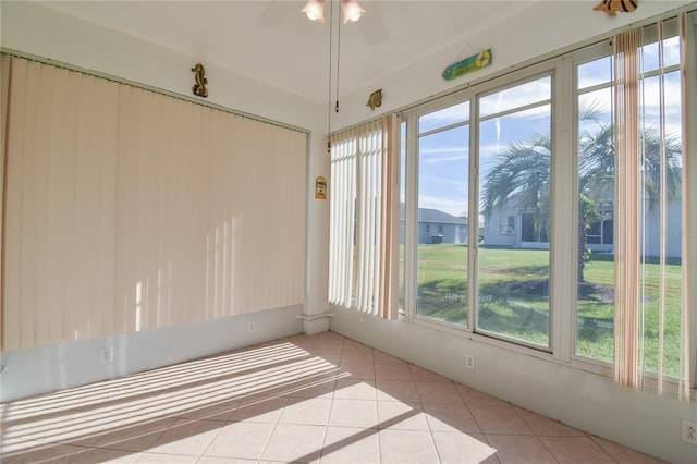 unfurnished sunroom featuring a wealth of natural light and ceiling fan