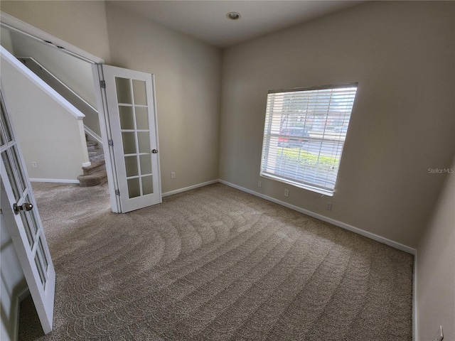 carpeted empty room with french doors