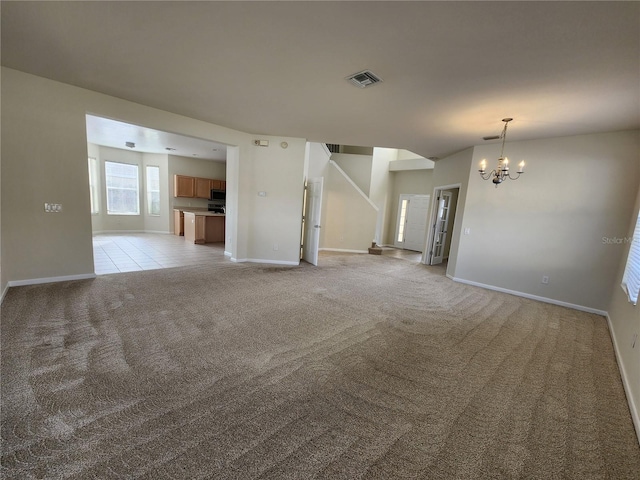 unfurnished living room with light colored carpet and a notable chandelier