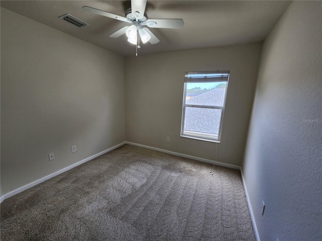 carpeted spare room featuring ceiling fan