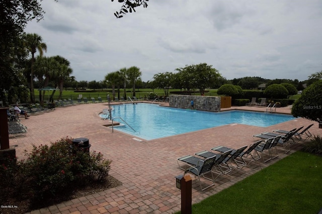 view of pool featuring pool water feature and a patio area