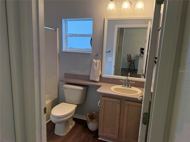 bathroom with vanity, toilet, and wood-type flooring