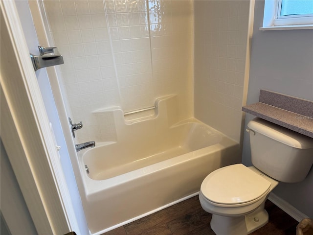 bathroom with hardwood / wood-style flooring, toilet, and shower / tub combination