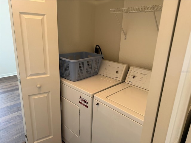 laundry area featuring washer and dryer and hardwood / wood-style floors