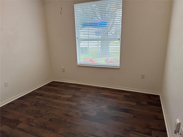 unfurnished room featuring dark wood-type flooring