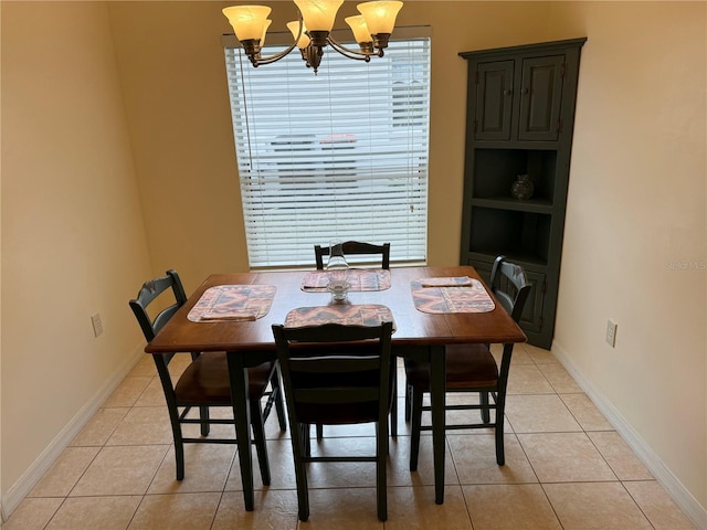 dining room with light tile patterned floors and a chandelier