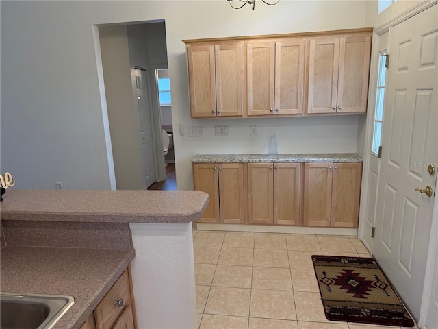 kitchen featuring light tile patterned floors and sink