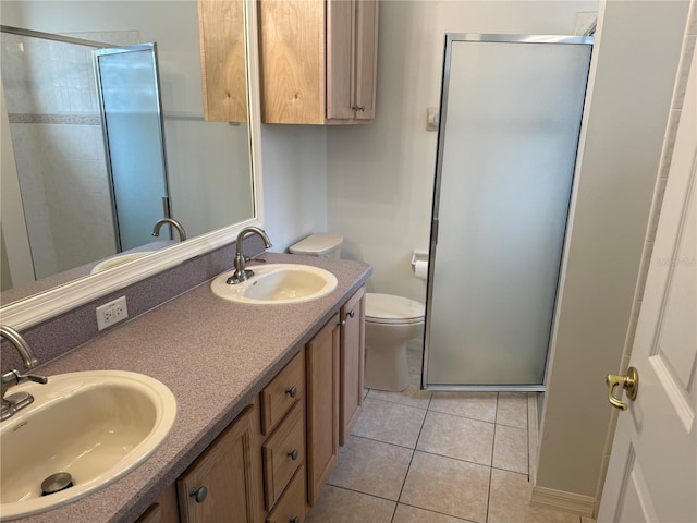 bathroom featuring tile patterned flooring, vanity, toilet, and a shower with shower door