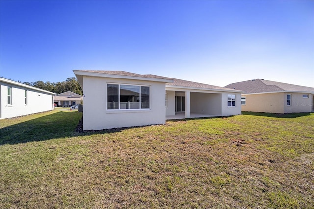 rear view of property with a lawn