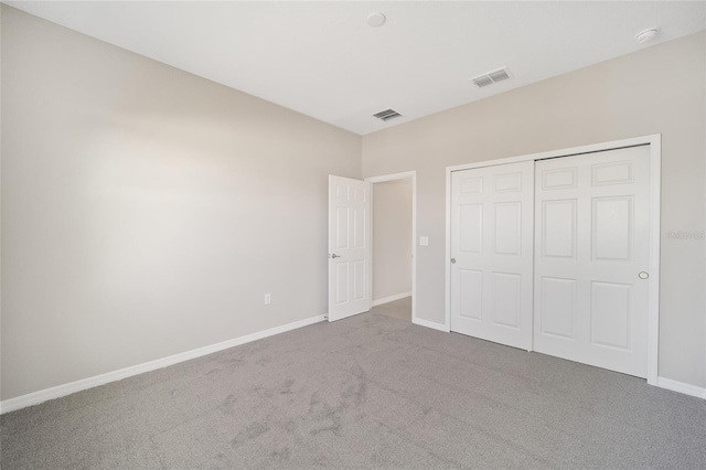 unfurnished bedroom featuring carpet and a closet