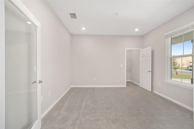 unfurnished bedroom with light colored carpet