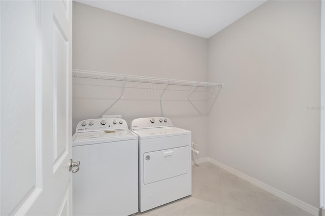 laundry room featuring independent washer and dryer and light tile patterned flooring