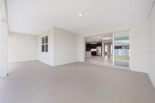 unfurnished living room featuring carpet flooring