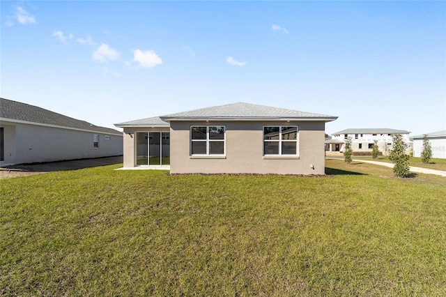 rear view of property featuring a yard