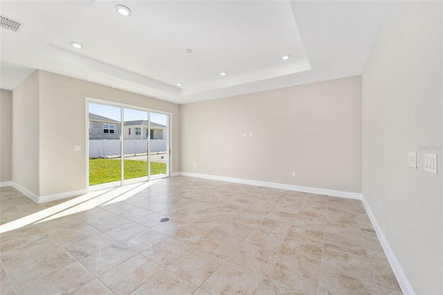 empty room featuring a tray ceiling