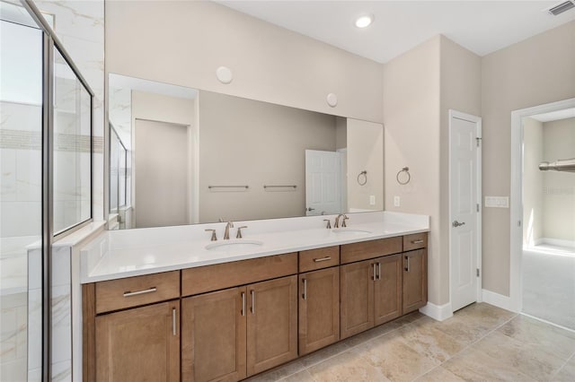 bathroom with a wealth of natural light, a shower with door, and vanity