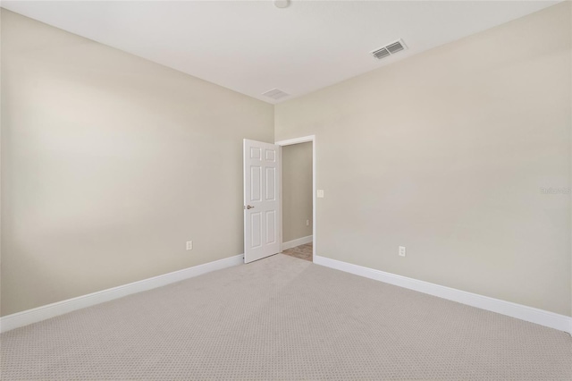 empty room with light colored carpet