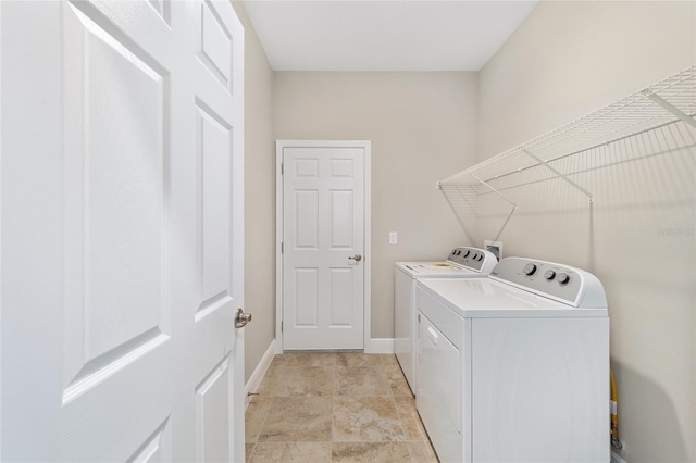 clothes washing area with washing machine and clothes dryer