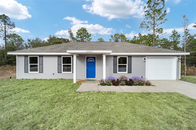 ranch-style house featuring a garage and a front lawn