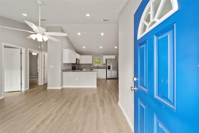 interior space with ceiling fan, light hardwood / wood-style flooring, and high vaulted ceiling