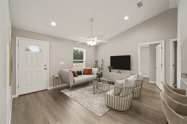 living room featuring ceiling fan, wood-type flooring, and vaulted ceiling