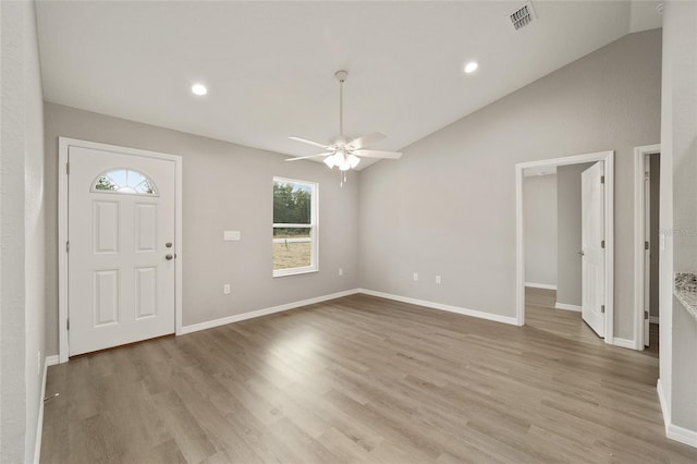 foyer entrance featuring ceiling fan, lofted ceiling, and light hardwood / wood-style flooring