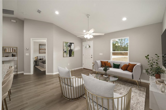 living room featuring dark wood-type flooring, ceiling fan, and lofted ceiling