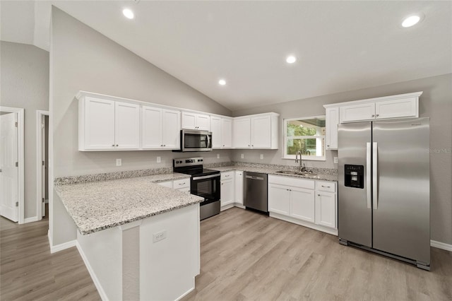 kitchen featuring light stone countertops, stainless steel appliances, kitchen peninsula, vaulted ceiling, and white cabinets