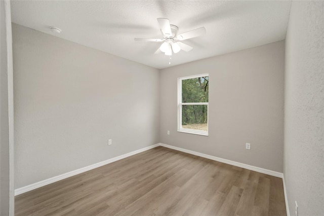 spare room featuring ceiling fan and light hardwood / wood-style floors