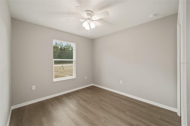 empty room featuring wood-type flooring and ceiling fan