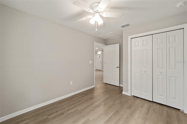 unfurnished bedroom with ceiling fan, light hardwood / wood-style floors, and a closet