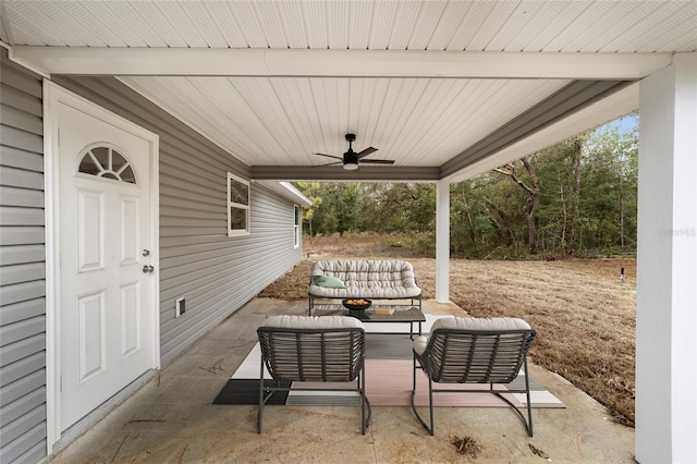 view of patio with an outdoor living space and ceiling fan