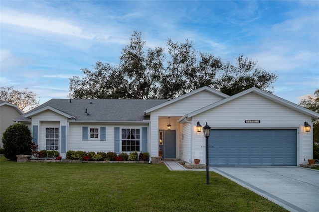 single story home featuring a garage and a front lawn