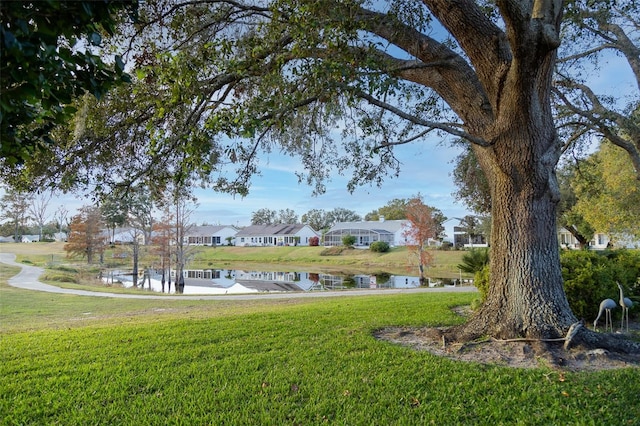 view of community featuring a yard and a water view