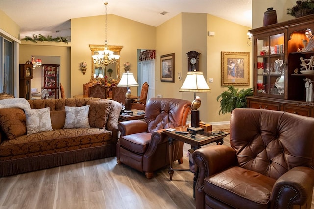 living area featuring wood-type flooring, vaulted ceiling, and an inviting chandelier