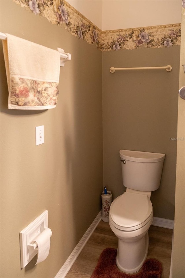 bathroom featuring wood-type flooring and toilet