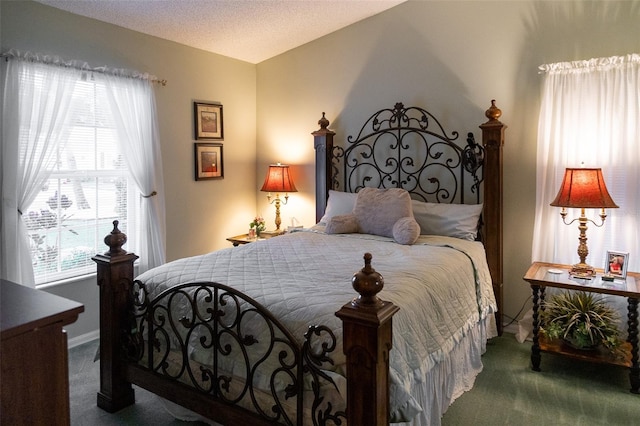 carpeted bedroom featuring a textured ceiling