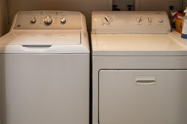 clothes washing area with independent washer and dryer