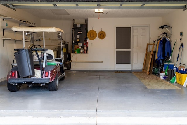 garage featuring heating unit and water heater