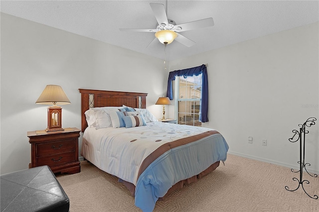 carpeted bedroom with a textured ceiling and ceiling fan