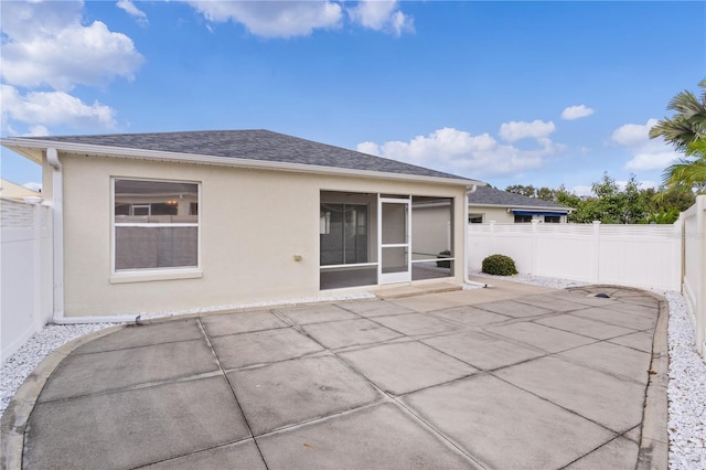 back of property featuring a patio and a sunroom