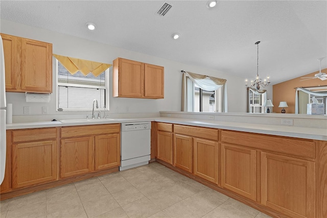 kitchen featuring vaulted ceiling, sink, pendant lighting, dishwasher, and kitchen peninsula