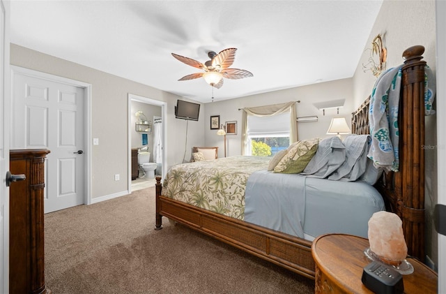 carpeted bedroom with ensuite bathroom and ceiling fan