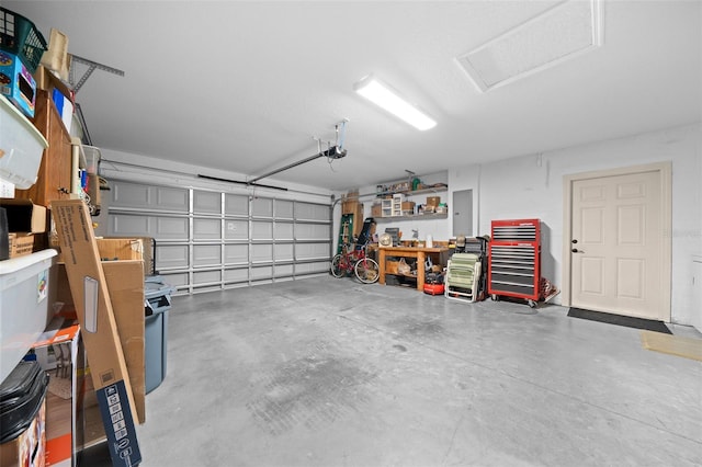 garage with electric panel and a garage door opener