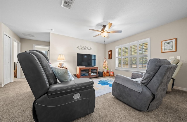 carpeted living room featuring ceiling fan