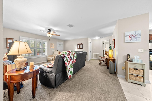 living room with light tile patterned floors and ceiling fan