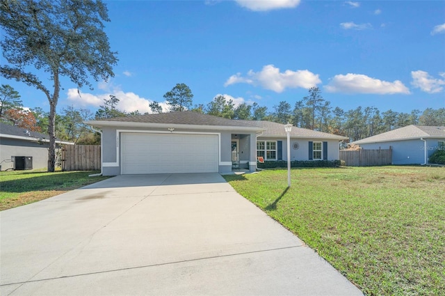 ranch-style house featuring cooling unit, a garage, and a front yard