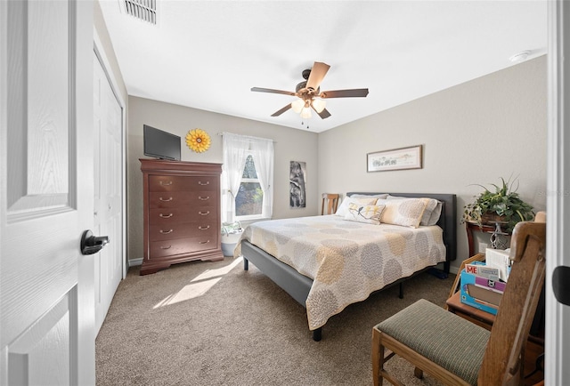 carpeted bedroom featuring ceiling fan and a closet